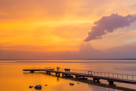 Sunset over water wit pierlake Narach Belarusの写真素材