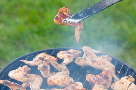 Chiken roasting on the grill barbeque bbq lawnの写真素材
