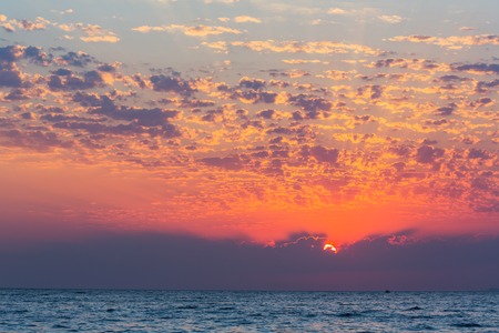 Colorful sunset over the sea with beautiful skyの写真素材