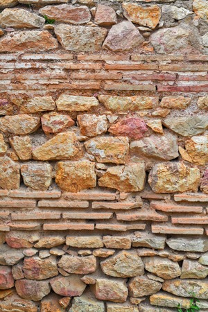 Natural old stone wall texture ancient buildingの写真素材