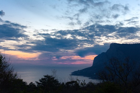 Seashore with cliffs at sunset summer evenong duskの写真素材
