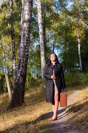 Woman in the park with old fashion trunk retro styleの写真素材