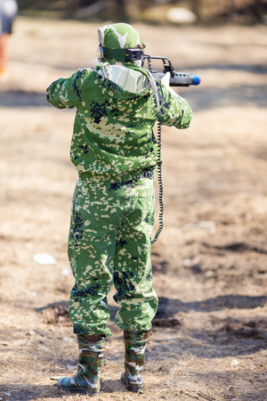 Boy with a gun playing lazer tag open airの写真素材