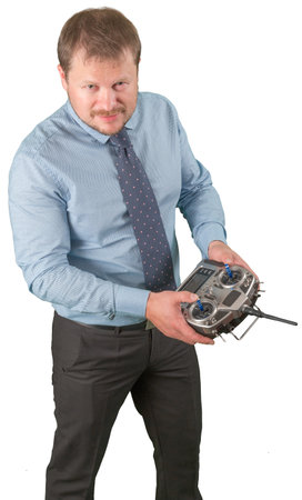 Man with flight remote controller in hands close up view on white background isolated