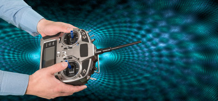 Flight remote controller in man's hands close up view on techno background