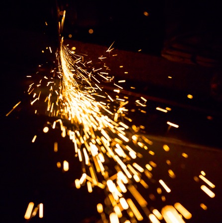 Sparks in the dark from a working grinding machineの写真素材