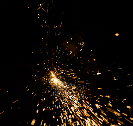 Sparks in the dark from a working grinding machineの写真素材