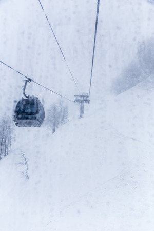 Ski elevator cabin in the mist view from window with drops bad weatherの写真素材