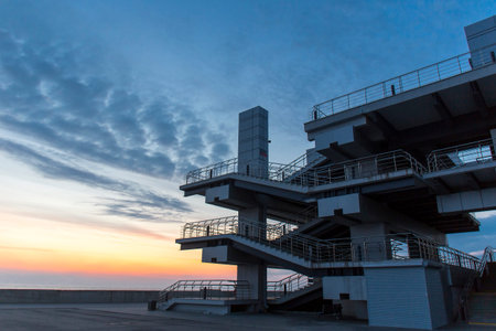 Modern architechture building on sea sunset sky background