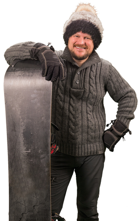 Man in sweater standing with snowboard on white backgroundの写真素材