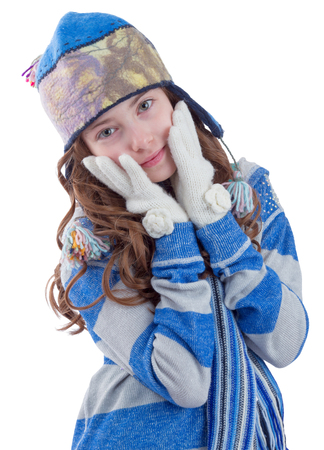 Pretty teen girl in winter clothes getting warm  on white backgroundの写真素材
