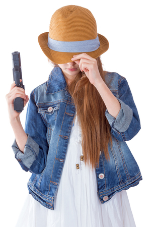 Pretty teen girl with a gun on white backgroundの写真素材