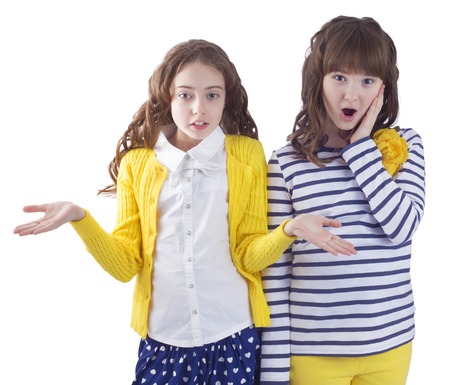 Two pretty surprised teengirls on white backgroundの写真素材