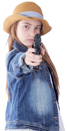 Pretty teen girl with a gun on white backgroundの写真素材