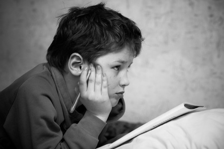 Young shoolboy preparing his homeworkの写真素材