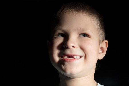 Cute boy missing some front teeth