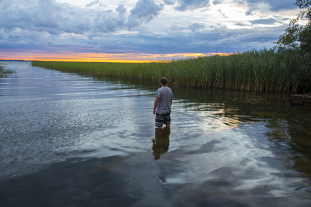 Man standing in a waterの写真素材