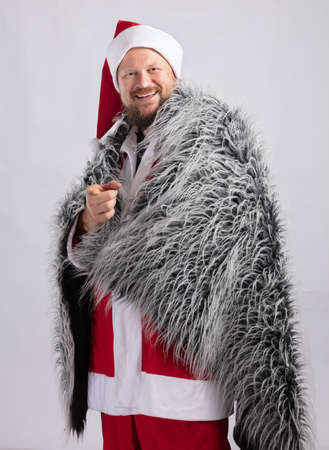 Cheerful Santa dressed in fur skin studio portraitの写真素材