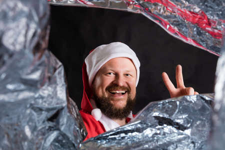 Cheerful Santa studio portrait on black background.の写真素材