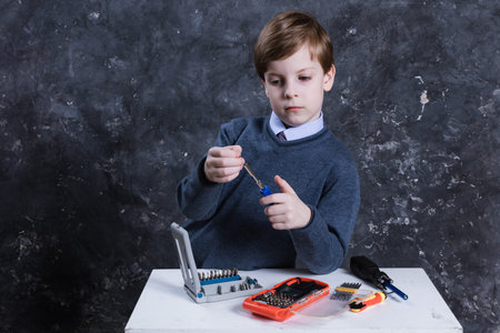 Cute boy with working tools studio portrait.