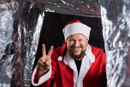 Cheerful Santa studio portrait on black background.の写真素材