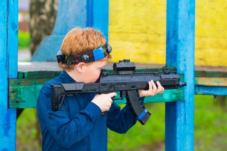 Boy with a gun playing laser tag