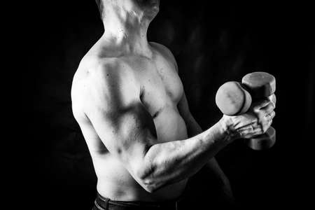 Matured man with naked muscular torso making exercisesの写真素材