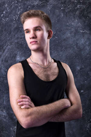 Young sportsman dressed in black vest studio portrait.の写真素材