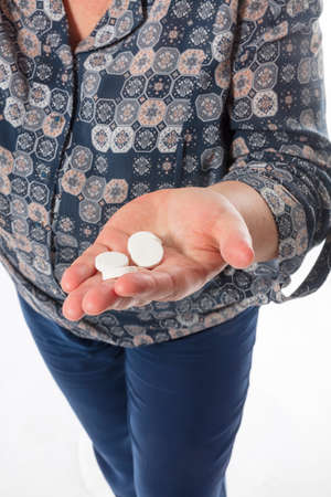 Middle aged housewife offers the tablets studio emotional portrait.の写真素材