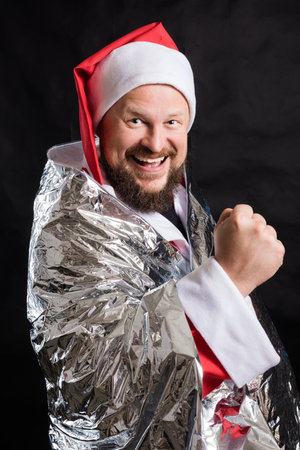 Cheerful Santa studio portrait on black background.の写真素材