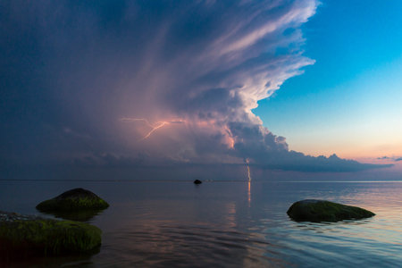 Beautiful scene with stormfront and lightning summer seascape.