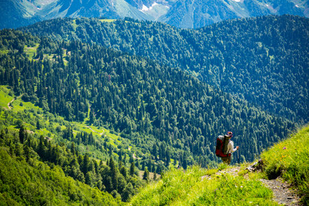 Beautiful mountain landscape with tourists hiking at Caucasus mountains.の写真素材