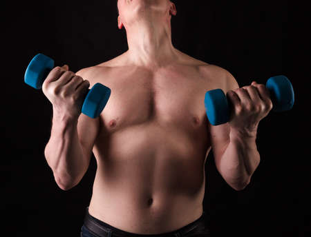 Matured man with naked muscular torso making exercisesの写真素材