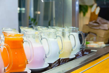 Yogurt and milk in glass jars standing in a rowの写真素材