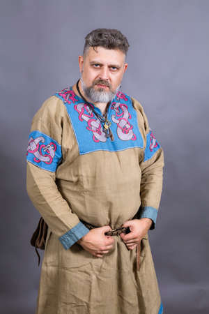 Mature bearded man in traditional historic medieval clothesの写真素材