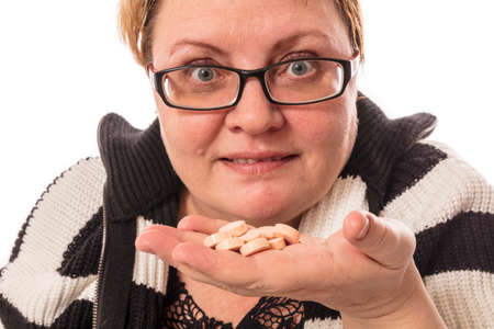 Middle aged housewife offers the tablets studio emotional portraitの写真素材