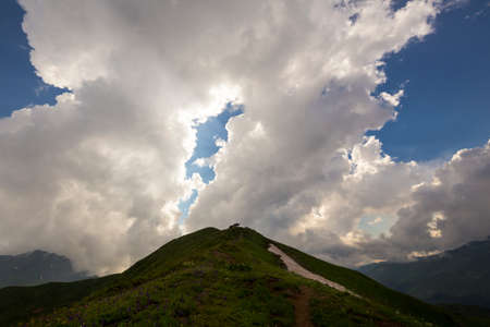 Beautiful mountain landscape at Caucasus mountains with clouds and blue skyの写真素材