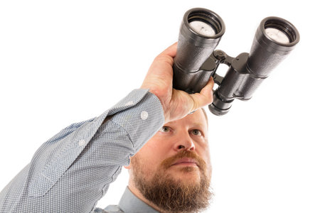 Soilid bearded man in shirt with binocularsの写真素材