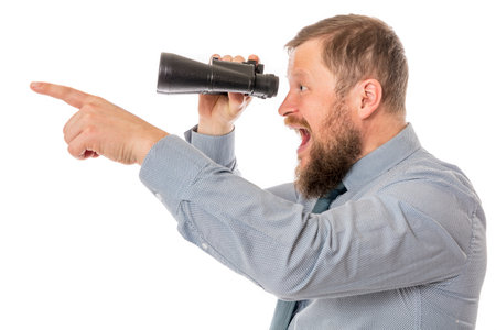 Soilid bearded man in shirt with binocularsの写真素材