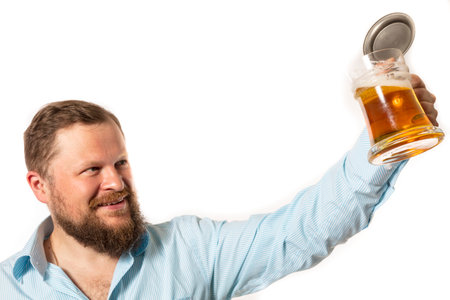 Solid smiling bearded man in shirt with beer mug studio portraitの写真素材