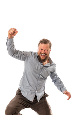 Joyful bearded man in shirt is happy to winの写真素材