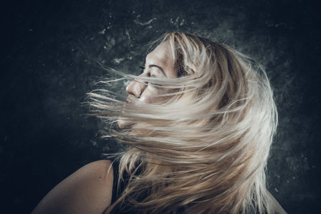 Attractive plump woman with flowing hair studio portrait close up view.の写真素材