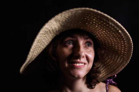 Cheerful 40 years old woman in wide-brimmed hat close up viewの写真素材