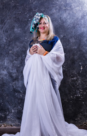 Attractive plump woman dressed in beautiful blue dressの写真素材