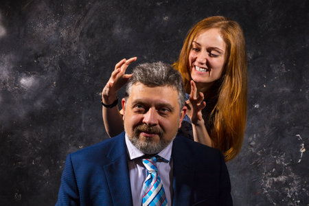 Bearded man and young woman, happy couple studio portrait..の写真素材