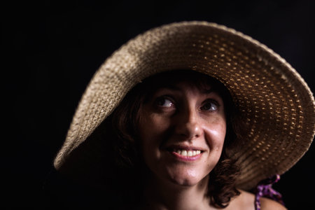 Cheerful 40 years old woman in wide-brimmed hat close up viewの写真素材