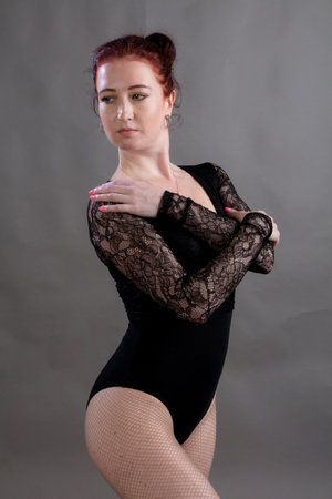 Beautiful dancer studio portrait standing on grey background.の写真素材