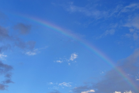 A photography of a blue sky rainbow backgroundの写真素材