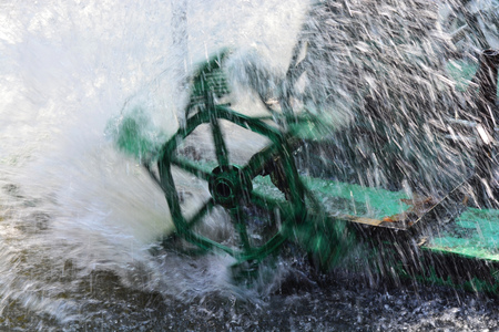 Aerator turbine wheel fill oxygen into water in fish farmの写真素材