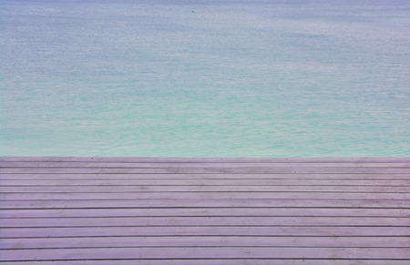wooden platform beside blue sky beachの写真素材